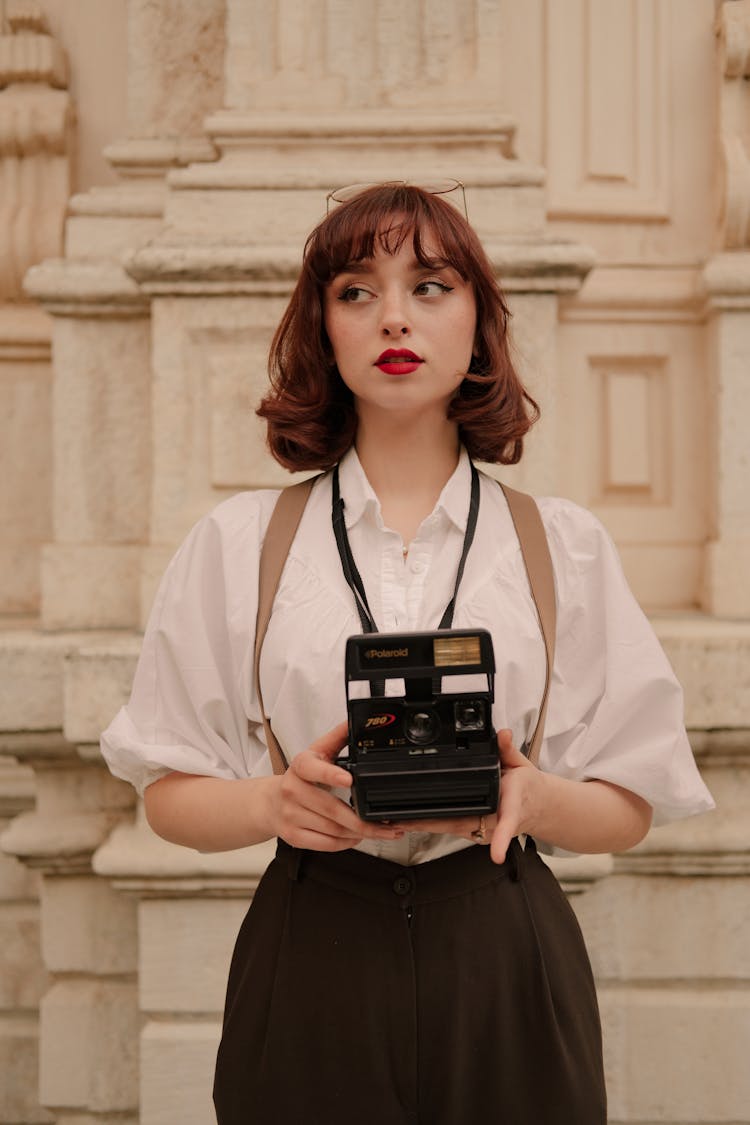 Portrait Of Woman Holding Vintage Camera