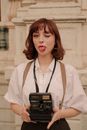 Woman in White Dress Shirt Holding Black Camera