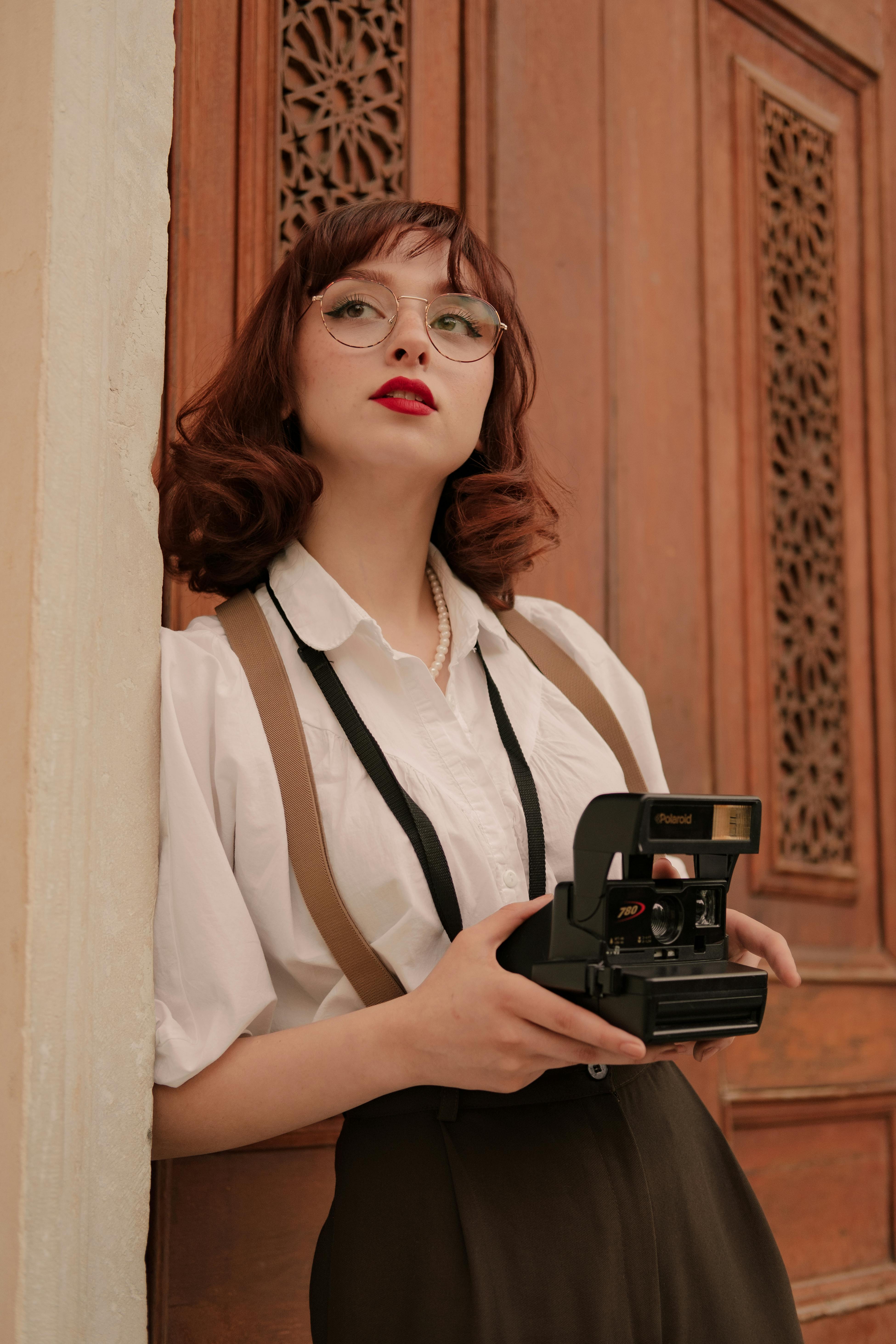 retro style portrait of woman with vintage camera