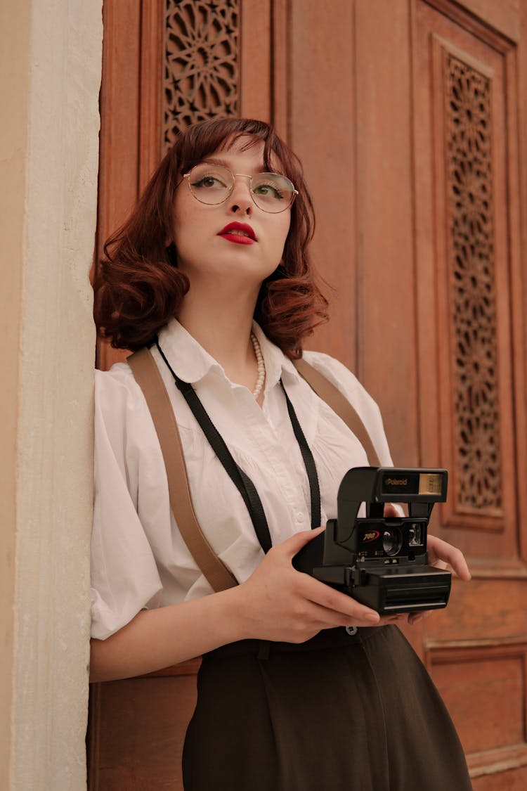 Retro Style Portrait Of Woman With Vintage Camera