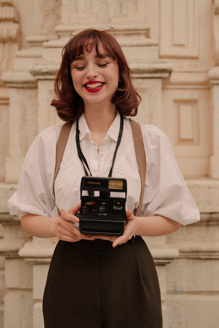 Retro Style Portrait Of Woman With Old Camera