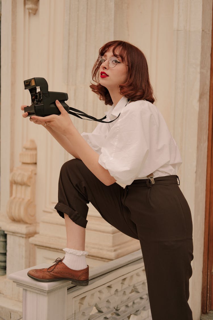 Portrait Of Woman Holding Old Camera