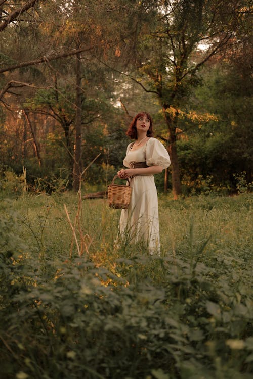 Free Retro Portrait of Woman with Basket in Meadow Stock Photo