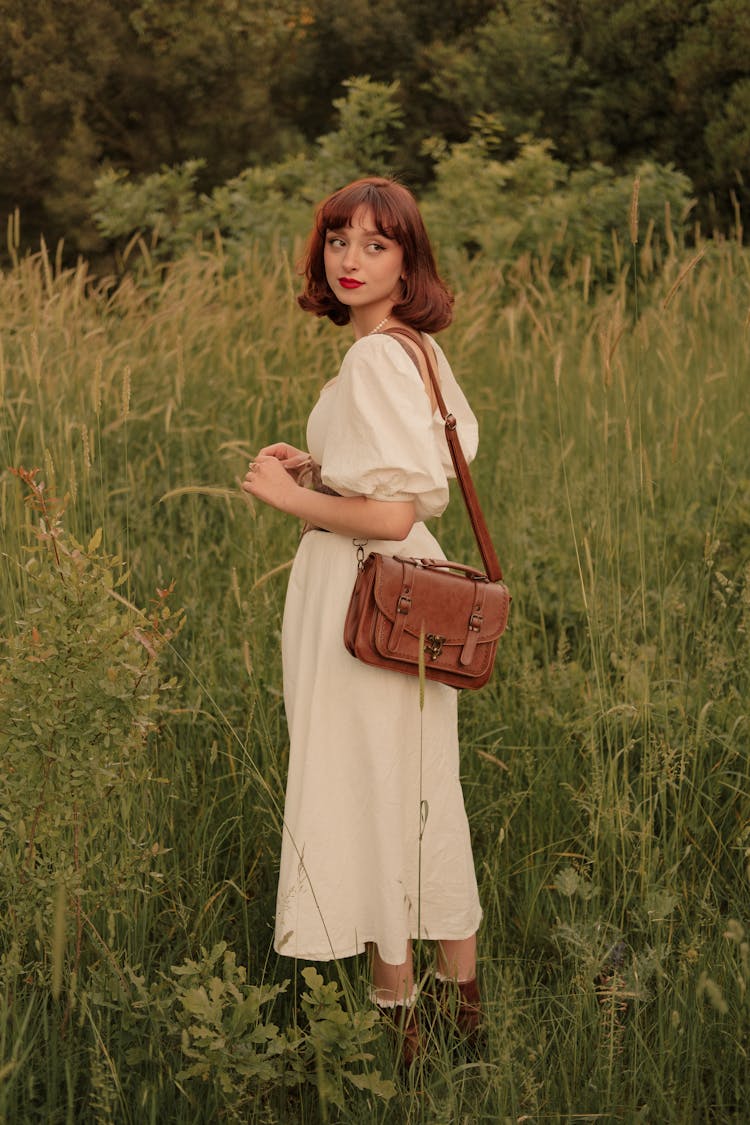 Portrait Of Woman With Purse And Dress In Meadow