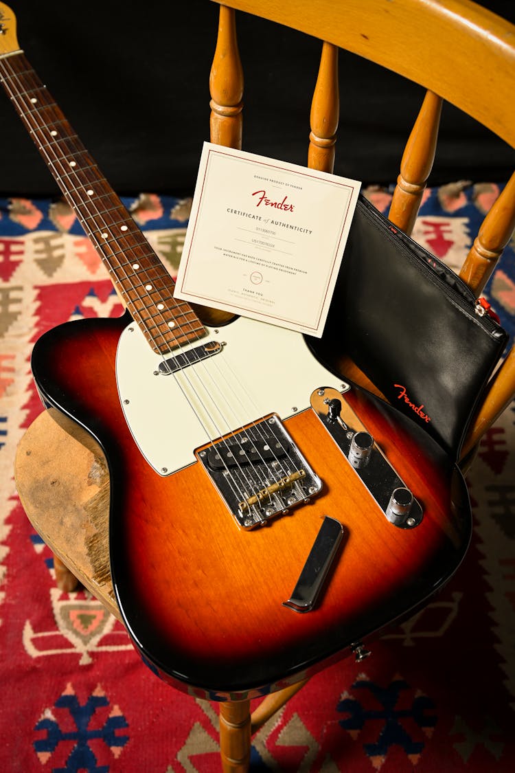 Guitar And Card On Chair