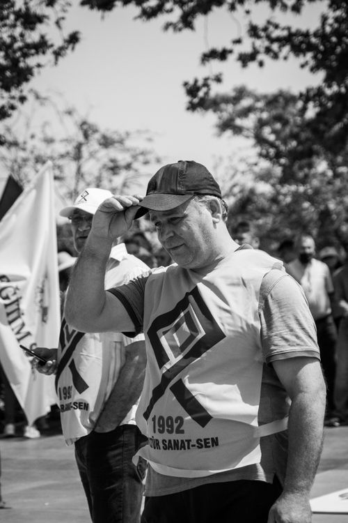 Free Black and white photo of a protest with men wearing graphic t-shirts, outdoors. Stock Photo