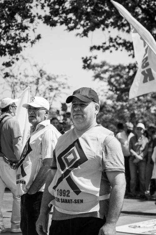 Free A black and white photo showing a community gathering or protest with men holding flags and banners. Stock Photo