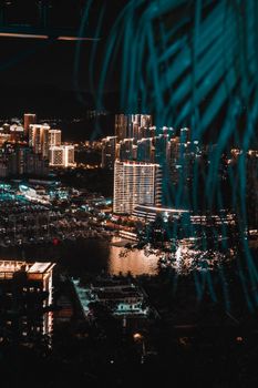 A mesmerizing aerial view of a city lit up at night, showcasing modern architecture and vibrant city lights.