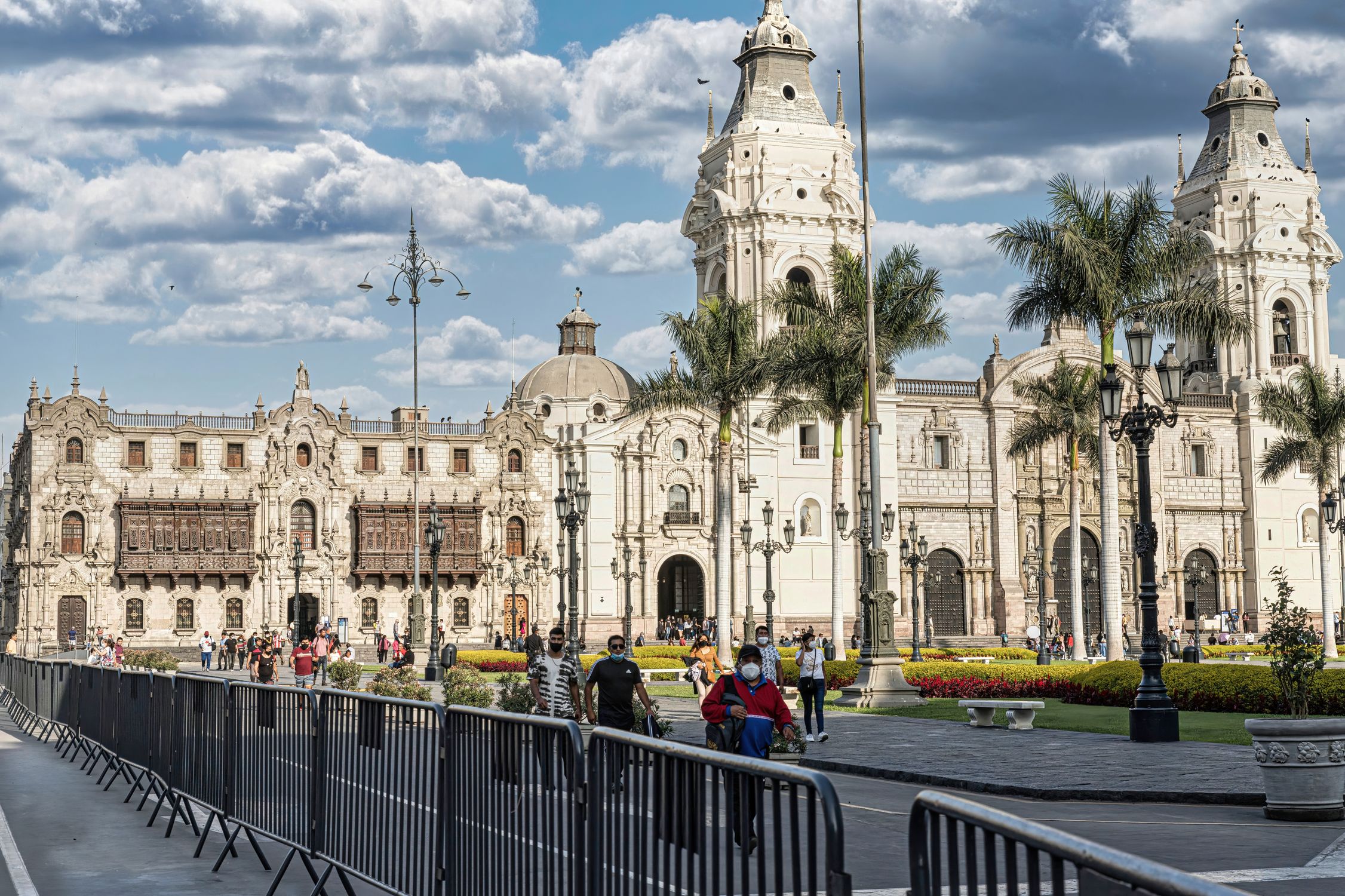 A bustling Plaza Mayor in Lima showcasing the historic Cathedral of Lima under blue skies