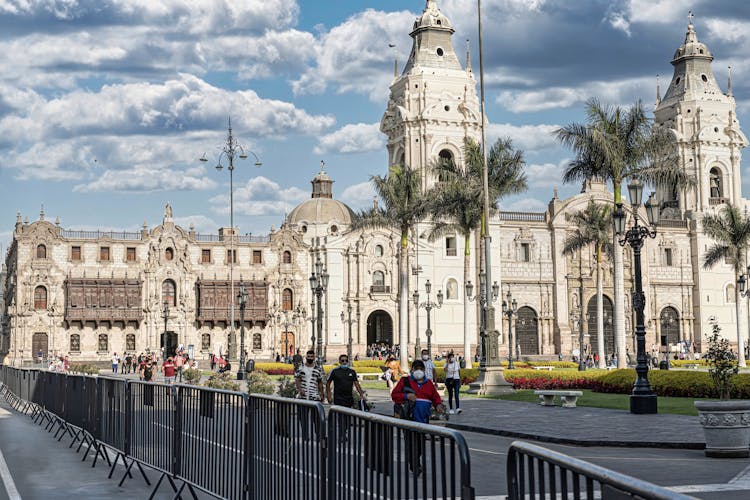 People Walking Near Gothic Historical Building