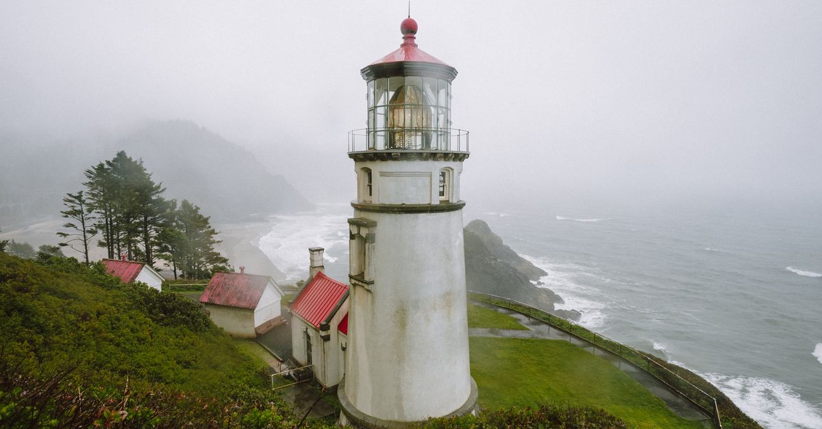 Heceta Head Lighthouse in Florence, Oregon, amid misty coastal scenery.