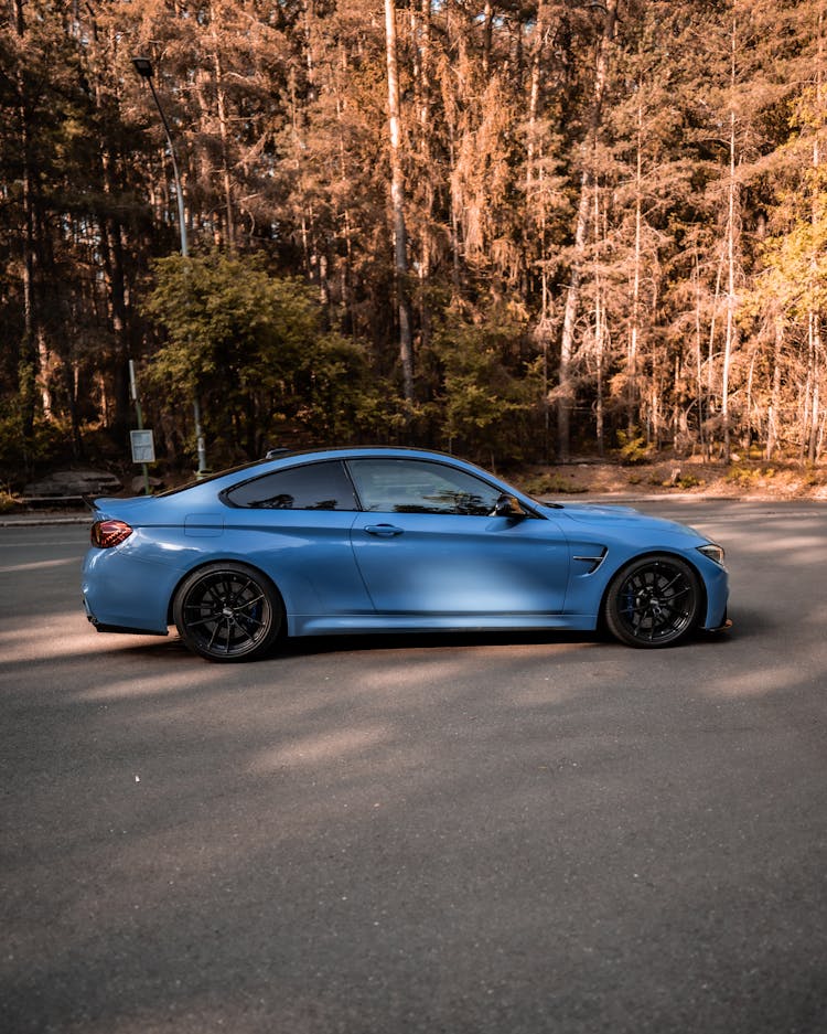 Blue BMW Car On Asphalt Pavement