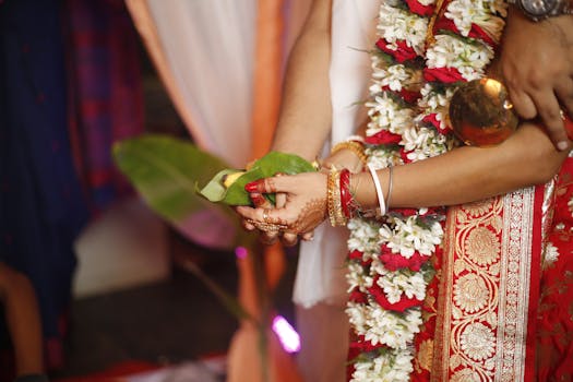 Close-up of a traditional Indian wedding ritual with banana leaf and floral garland in Kolkata, India.