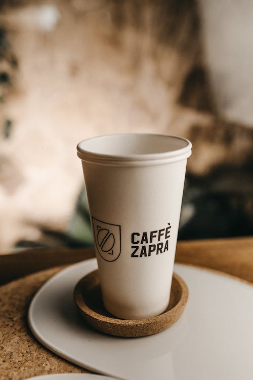 A White Paper Cup on Brown Cork Coaster