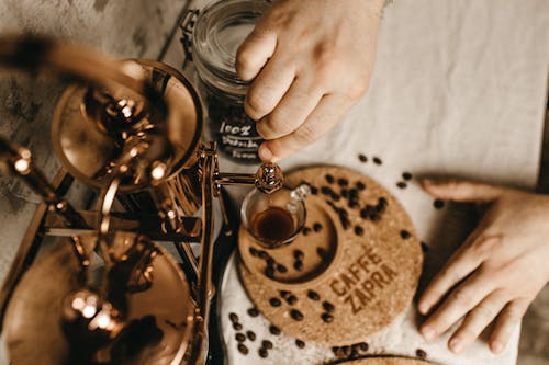 Free Hands Pouring Coffee into Glass Stock Photo