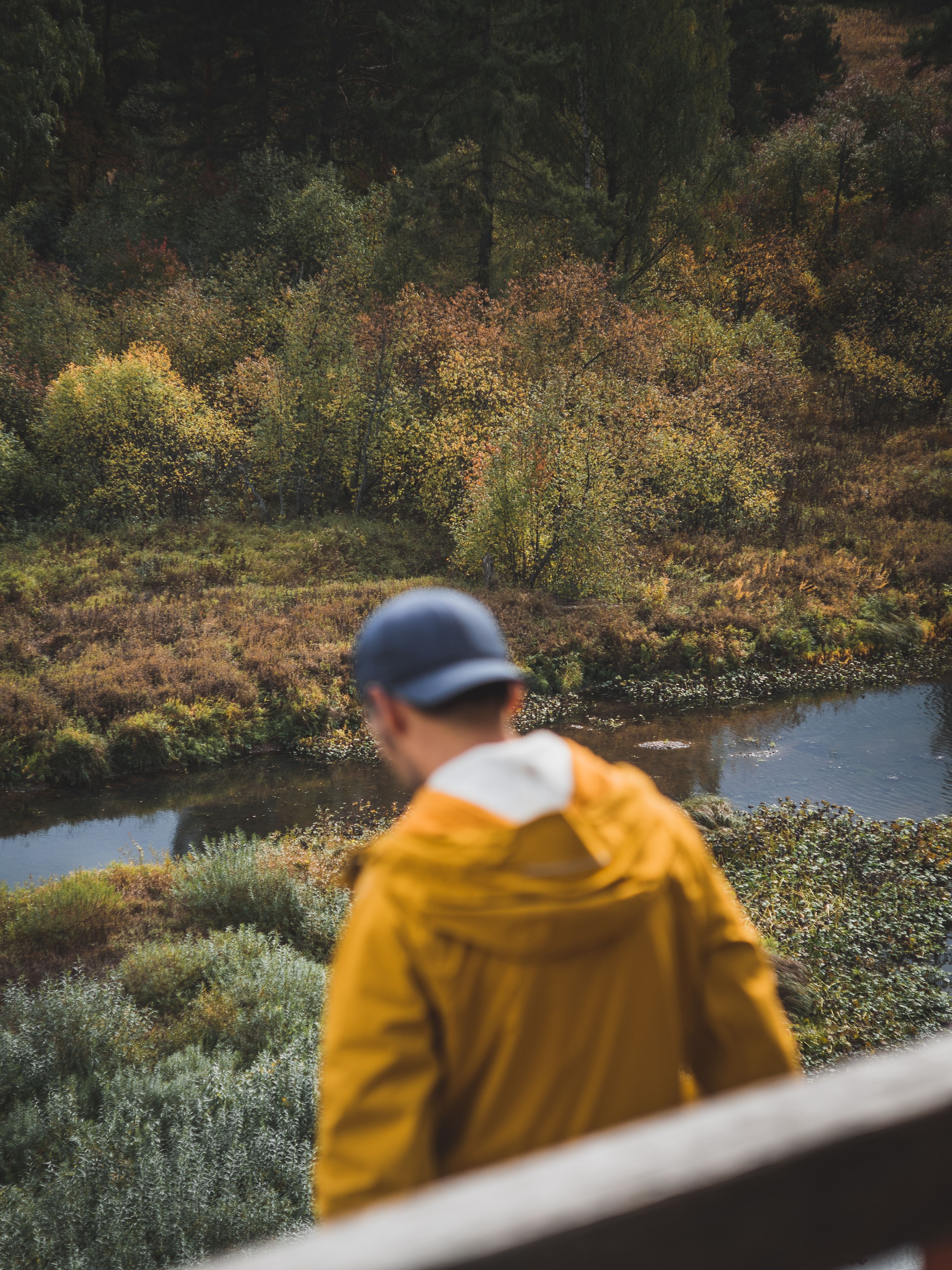 Man in Yellow Jacket Standing Near River · Free Stock Photo