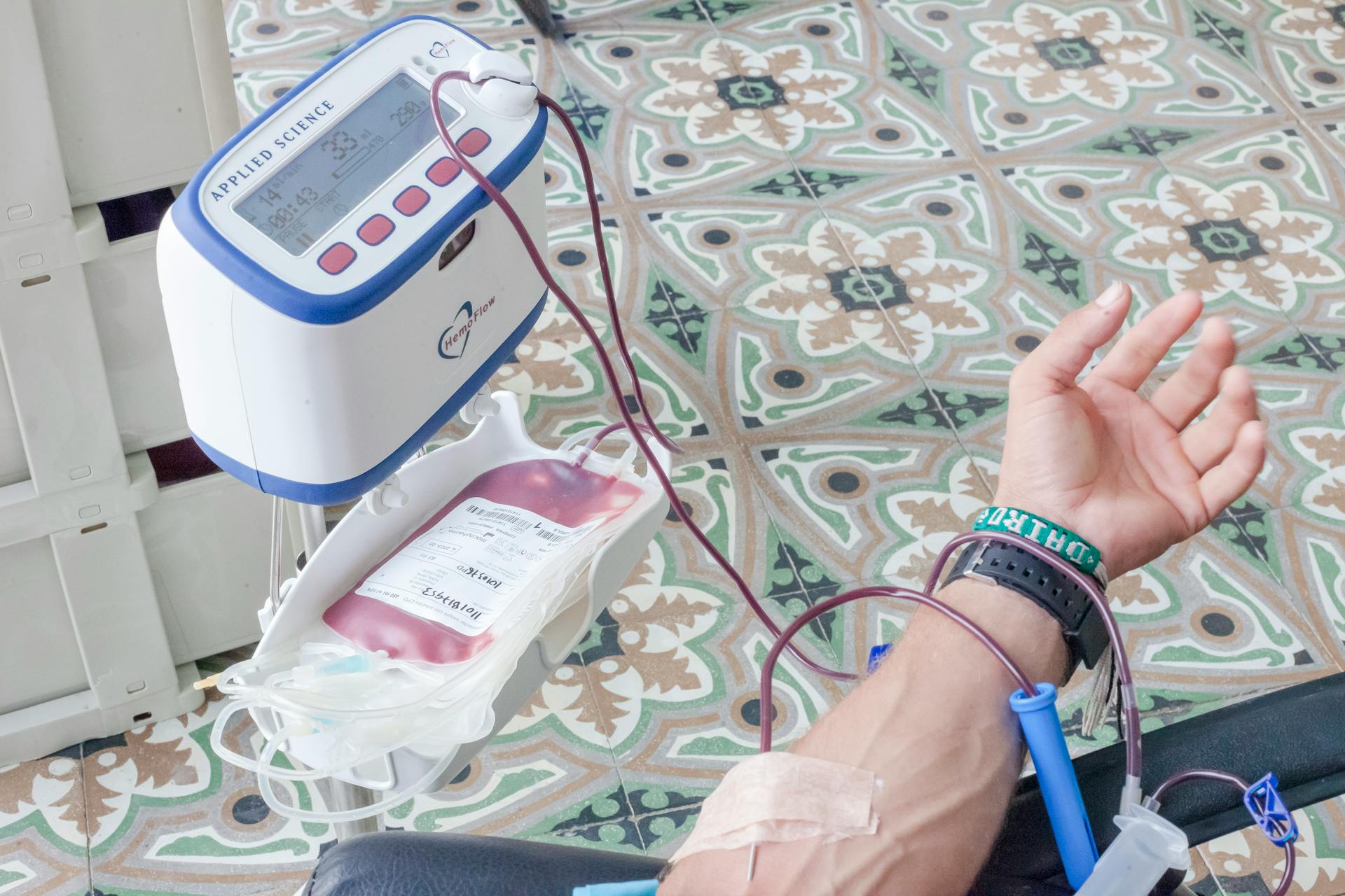 A Blood Collector Attached on a Person's Hand