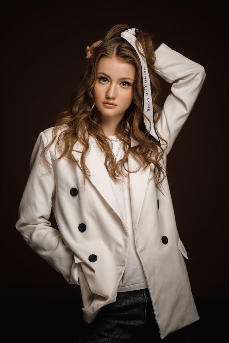 Attractive Young Woman In White Jacket With Black Buttons