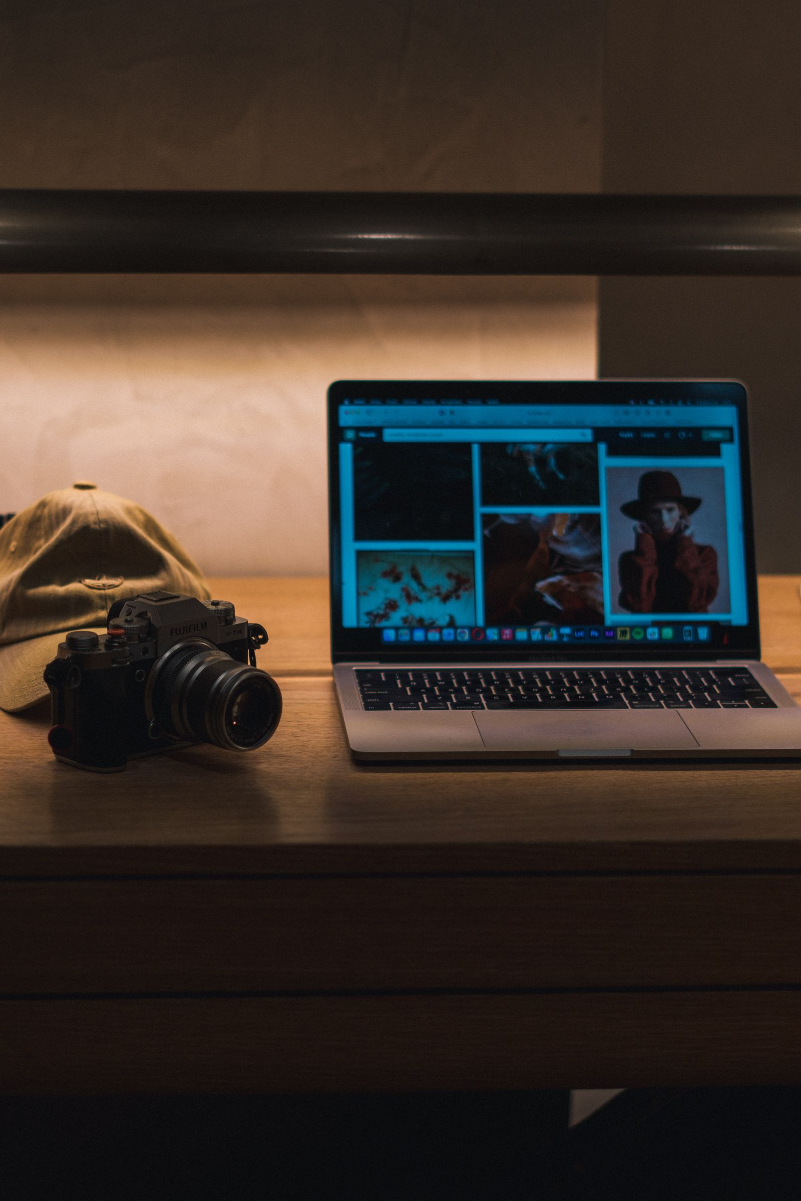 Camera and laptop in a warm content creation workspace