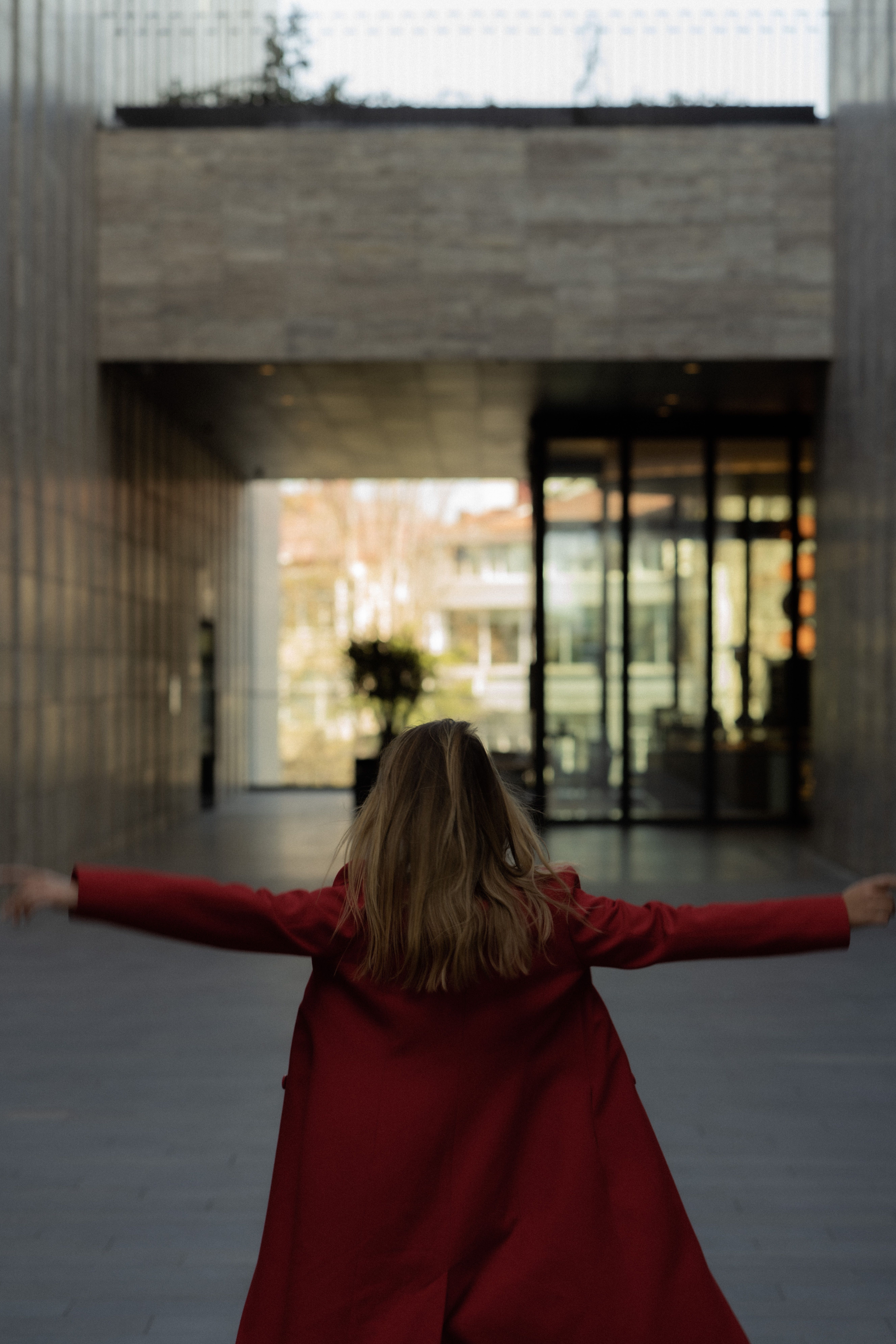 Back View of a Woman Wearing Her Red Coat · Free Stock Photo