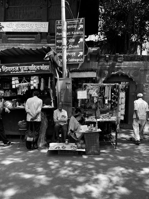 Grayscale Photo of People Selling on Street