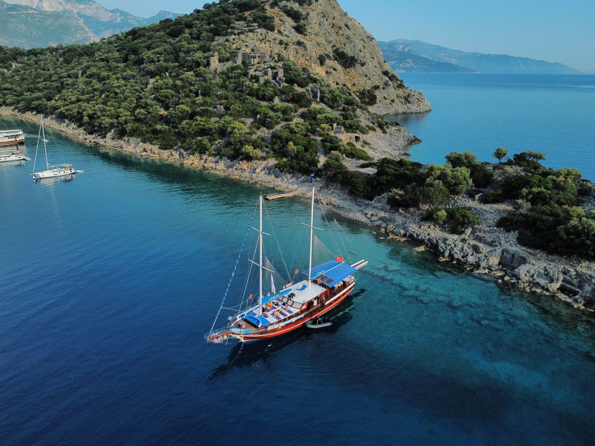 Aerial Photography of Boats on Blue Ocean near Island · Free Stock Photo