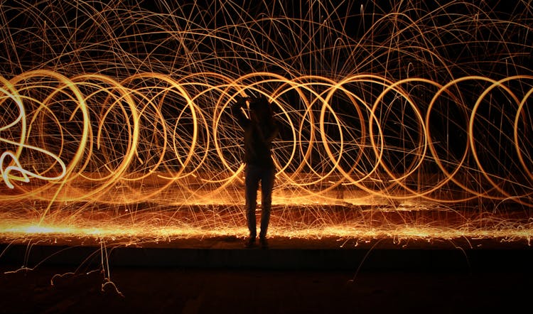 Silhouette Of A Person Standing Near Spiral Lights 