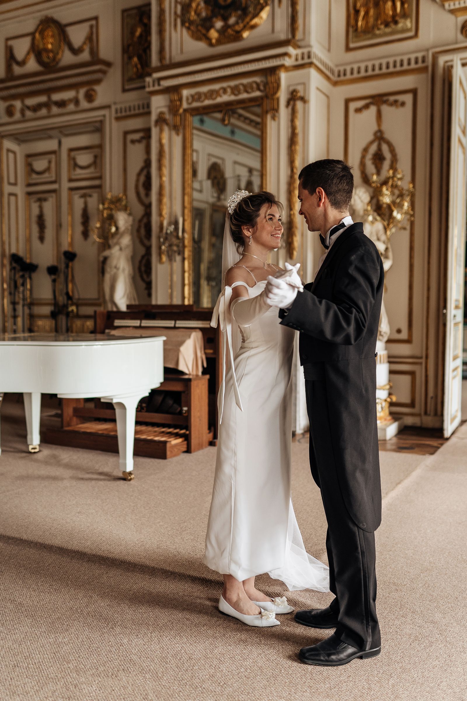 Elegant smiling couple dancing in a grand ballroom
