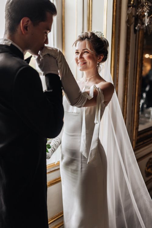 Free Bride and groom sharing a romantic moment indoors on their wedding day. Stock Photo