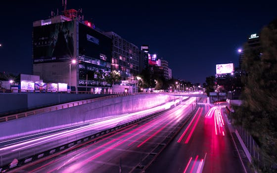 Vibrant long exposure of city traffic lights at night in Ciudad de México, highlighting urban life.