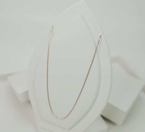 Free Minimalist gold necklace showcased on a white display stand, perfect for jewelry lovers. Stock Photo