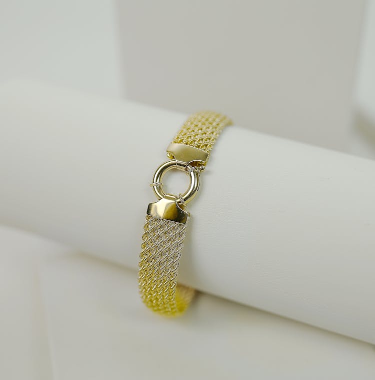 Gold And Silver Link Bracelet On A Holder