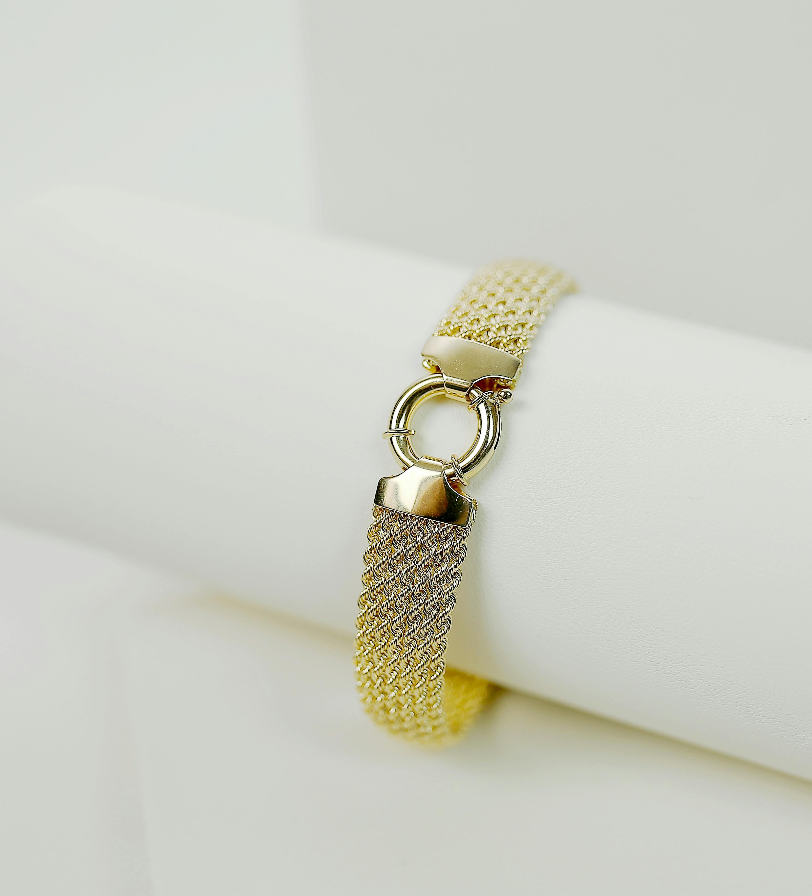 gold and silver bracelet in close up photography