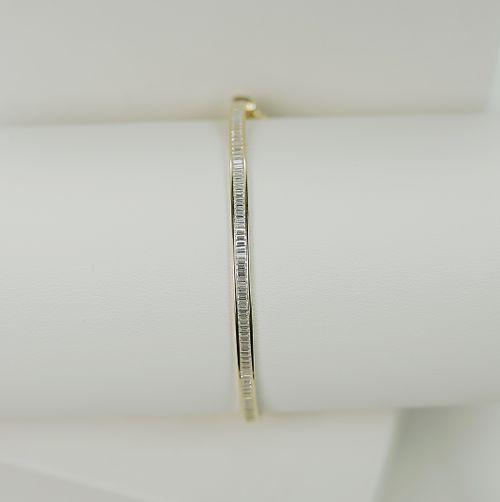 Free Close-up of a luxurious gold bracelet with diamonds on a white background, showcasing elegance. Stock Photo