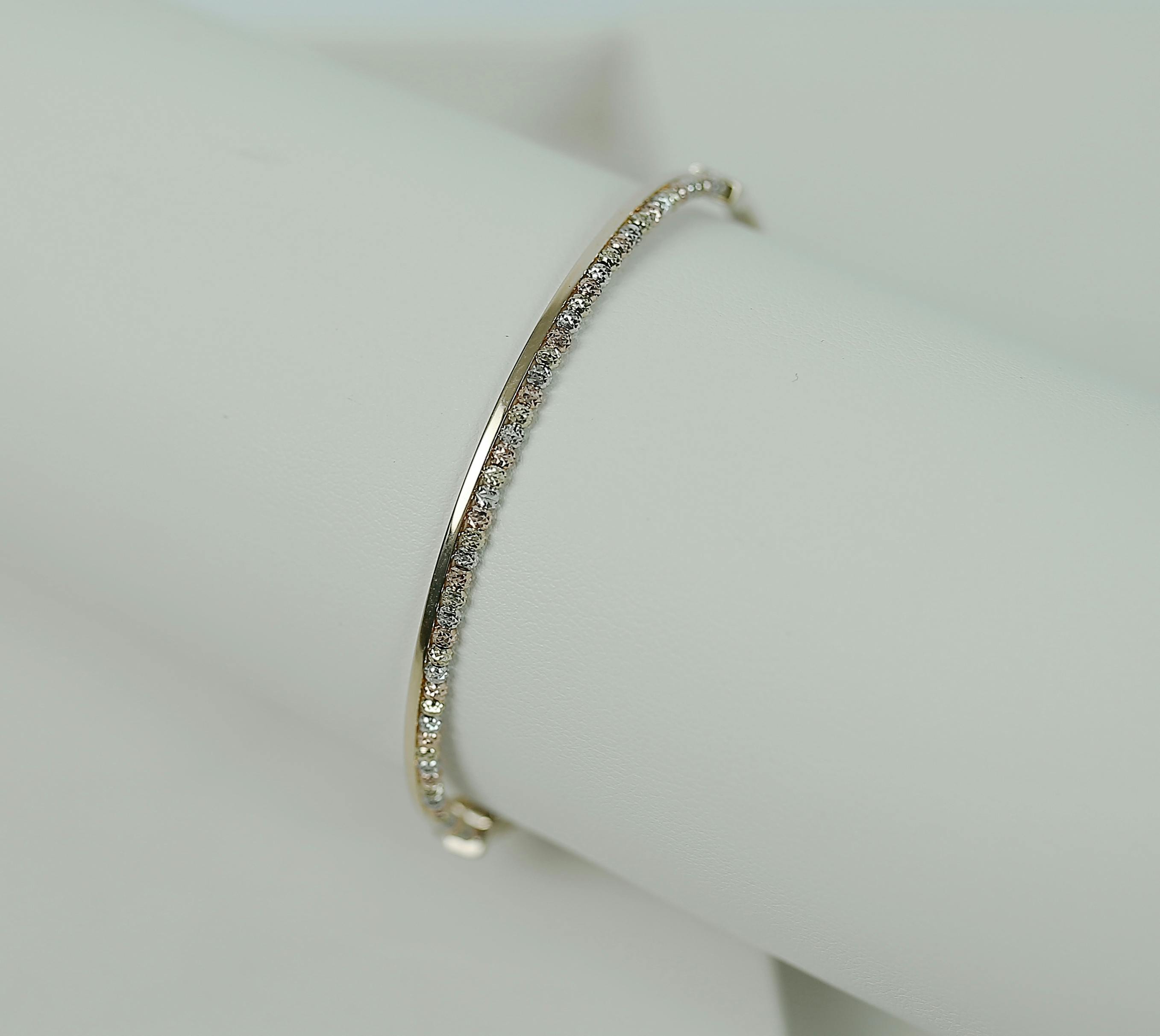 a white gold bracelet with diamonds on a holder