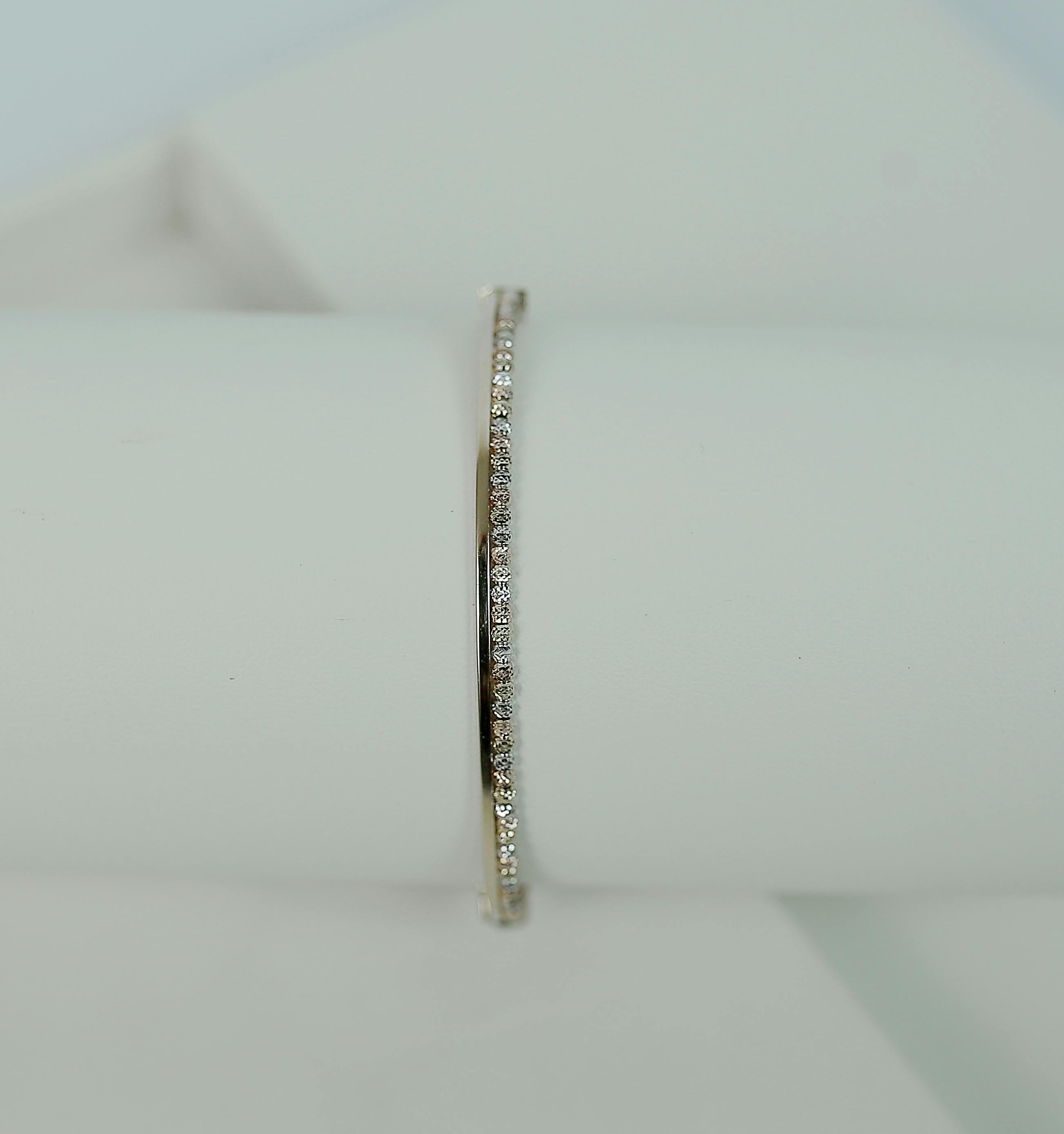 a white gold bracelet with diamonds on a holder