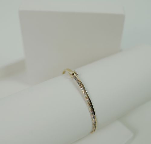 Free Close-up of a luxurious gold bracelet with diamonds on a white background. Stock Photo