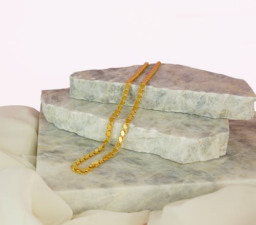 Gold Necklace on a Stone