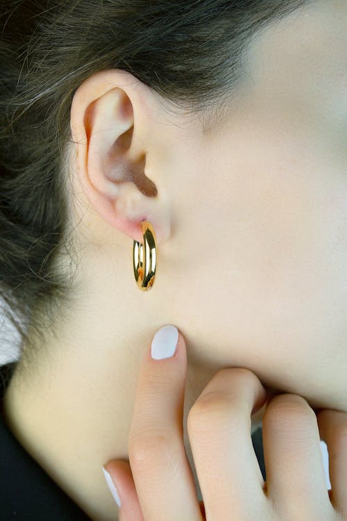 Woman Wearing a Gold Earring