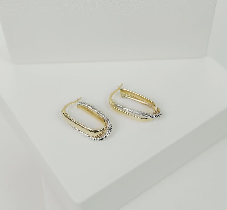 A Pair Of Gold And Silver Earrings