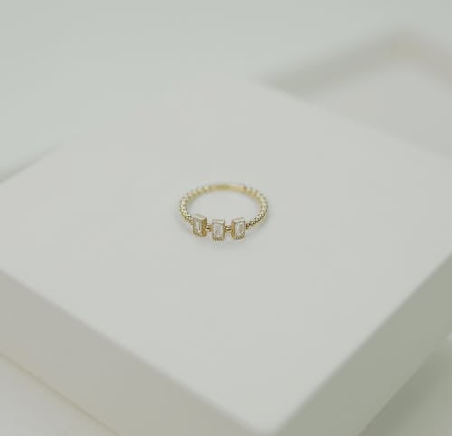 Free Gold Diamond Ring on White Surface Stock Photo