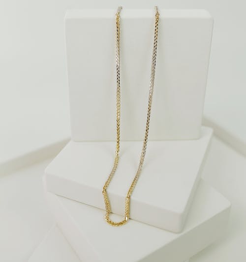 Beautiful Gold Necklace on White Platform