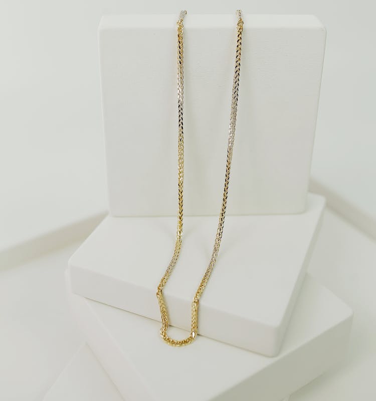 Beautiful Gold Necklace On White Platform