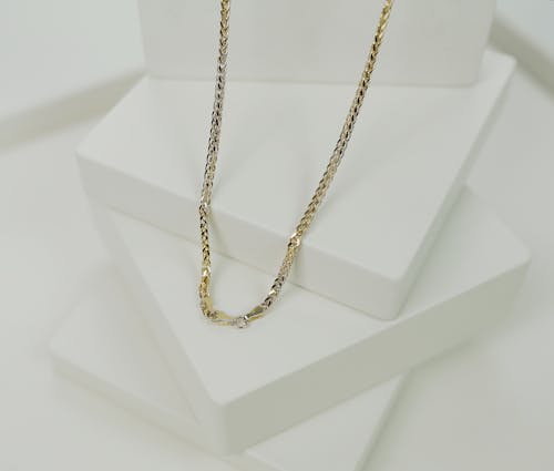 Gold Necklace in Close-up Photography