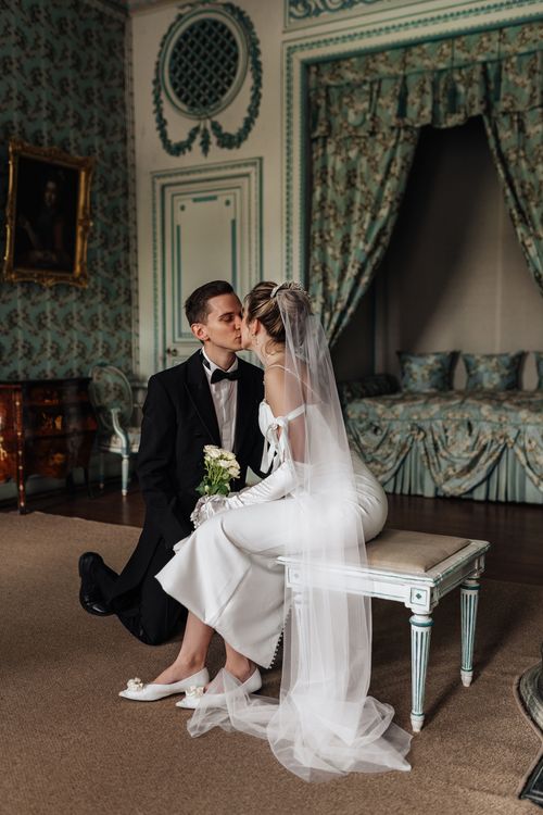 Free Bride and groom share a romantic kiss in a luxurious indoor setting in Moscow. Stock Photo