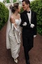 Man in Black Suit and Woman in White Dress