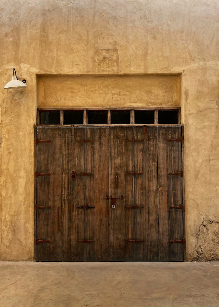 Brown Wooden Door On Brown Concrete Wall