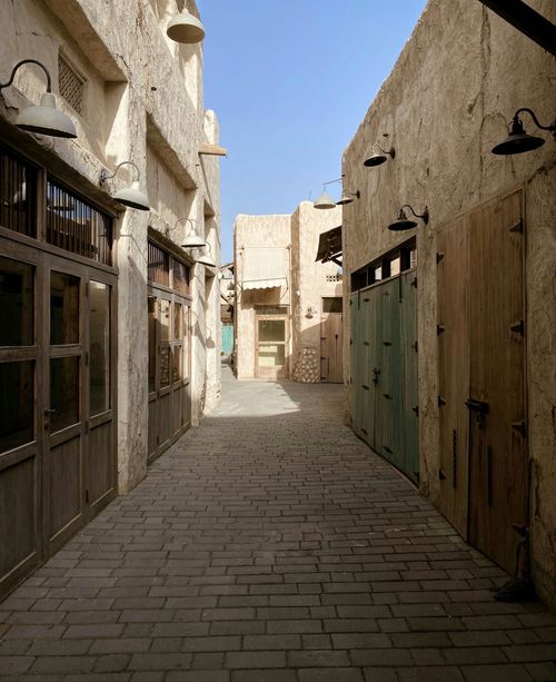 Free Explore a quiet stone-paved alleyway in Dubai's cultural heritage district, showcasing rustic architecture. Stock Photo