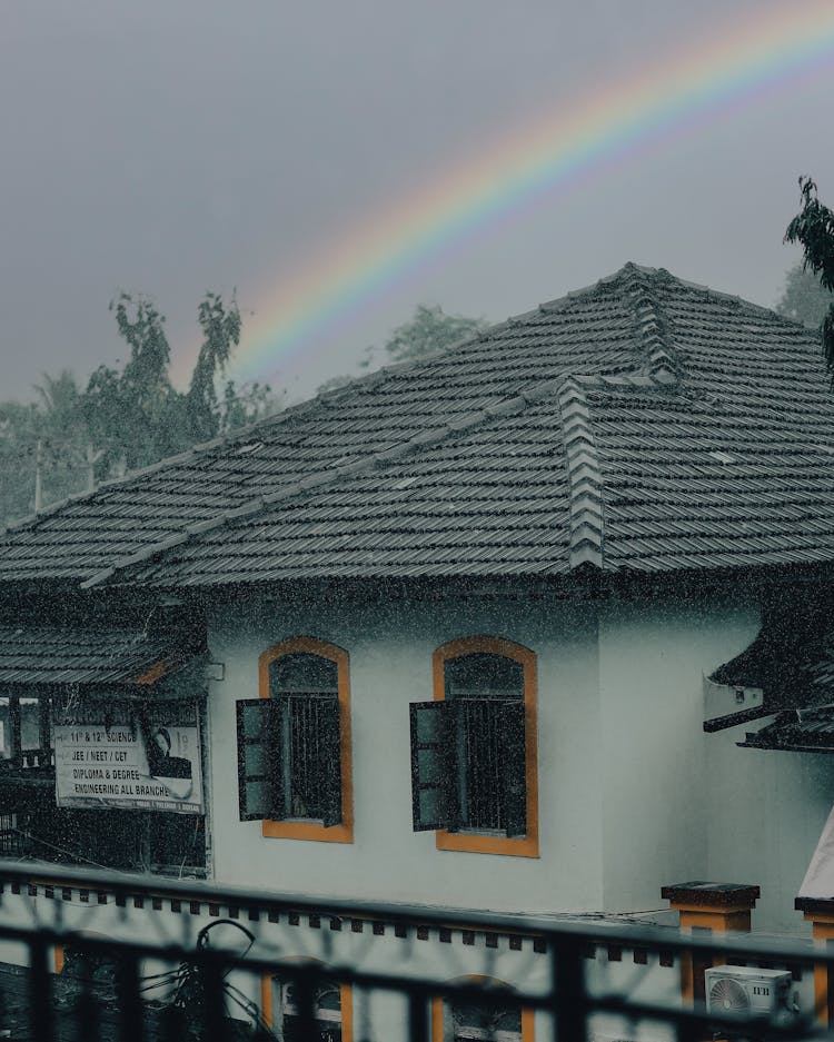 Rainbow Over A House During Rain