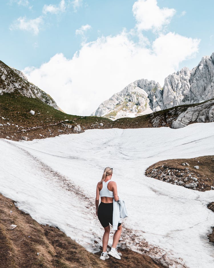 Backview Of Female Hiker On Mountains 